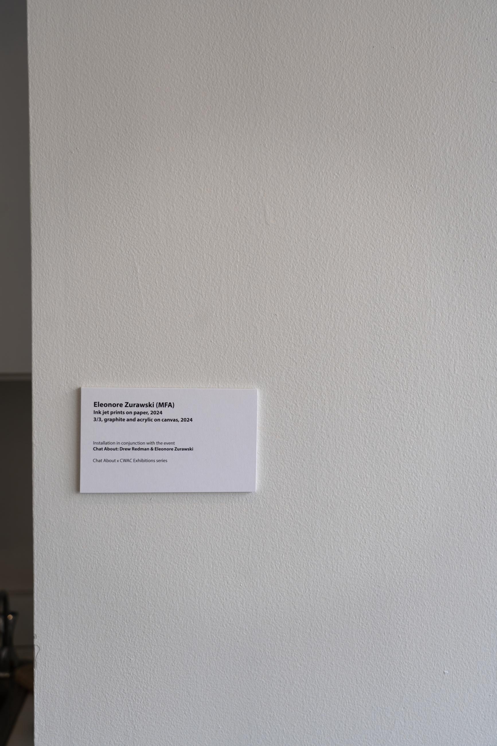 wall label detailing the artist and medium of works
