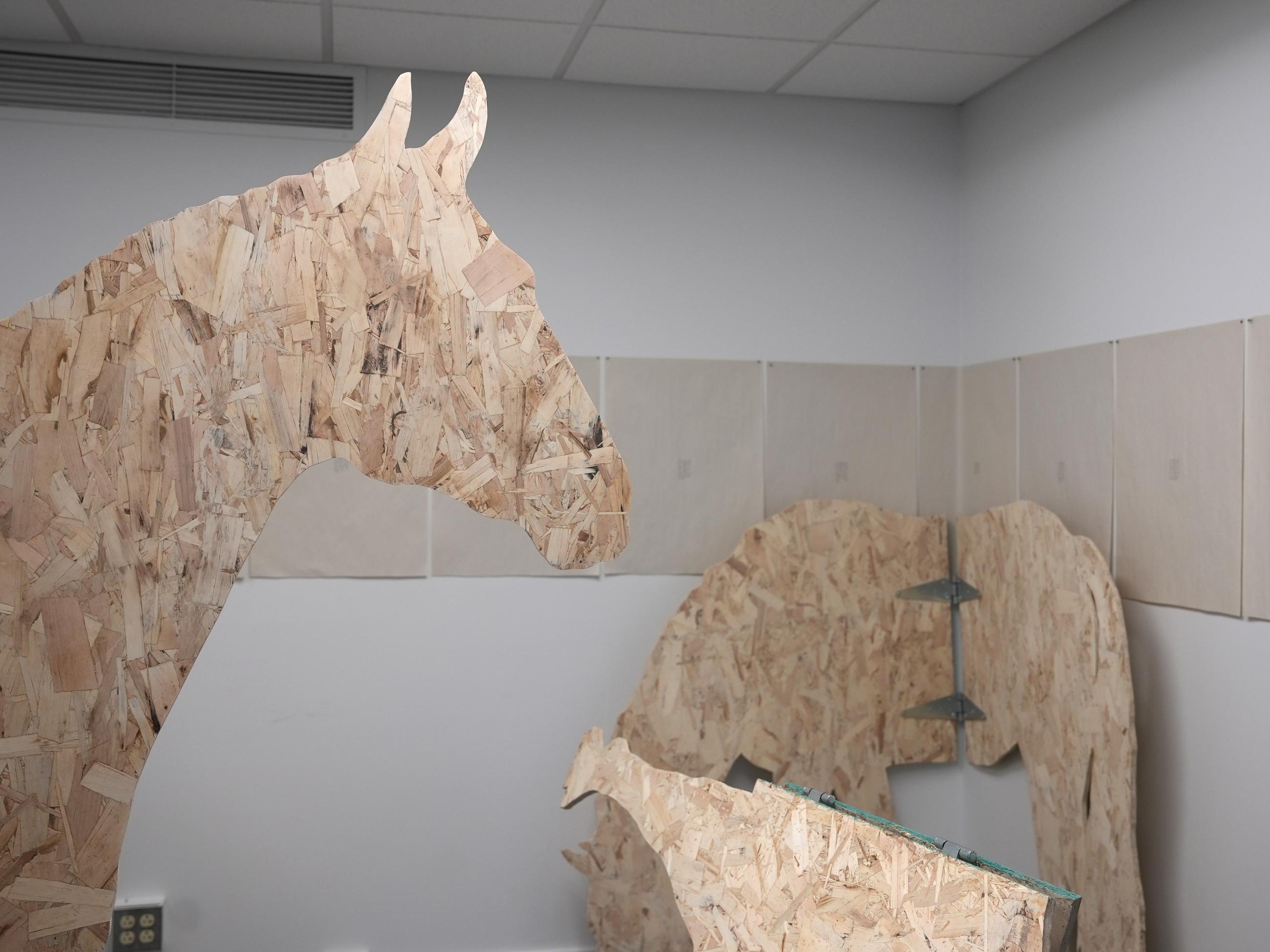 life-size silhouettes of horses made from plywood, hinged