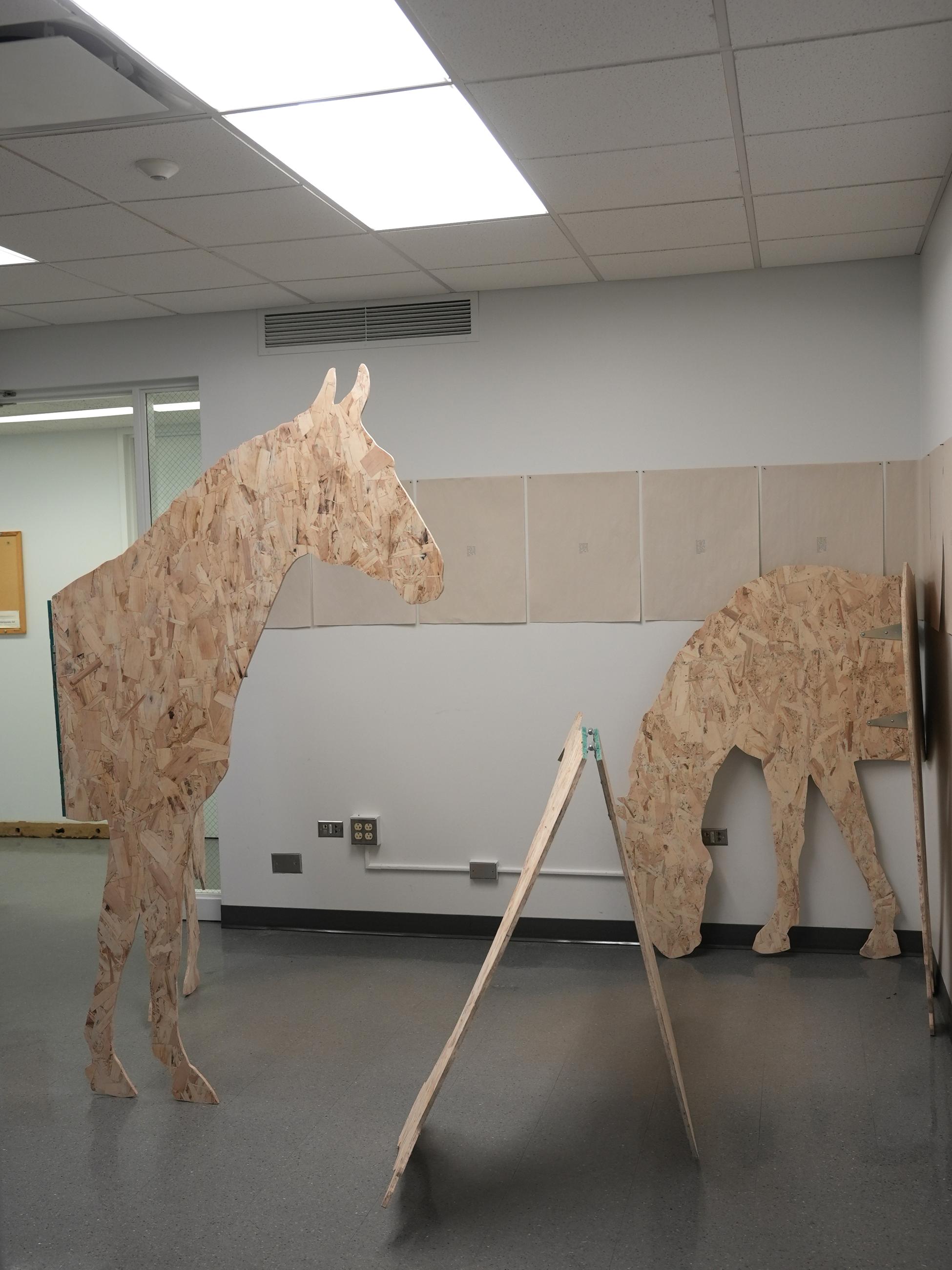 life-size silhouettes of horses made from plywood, hinged