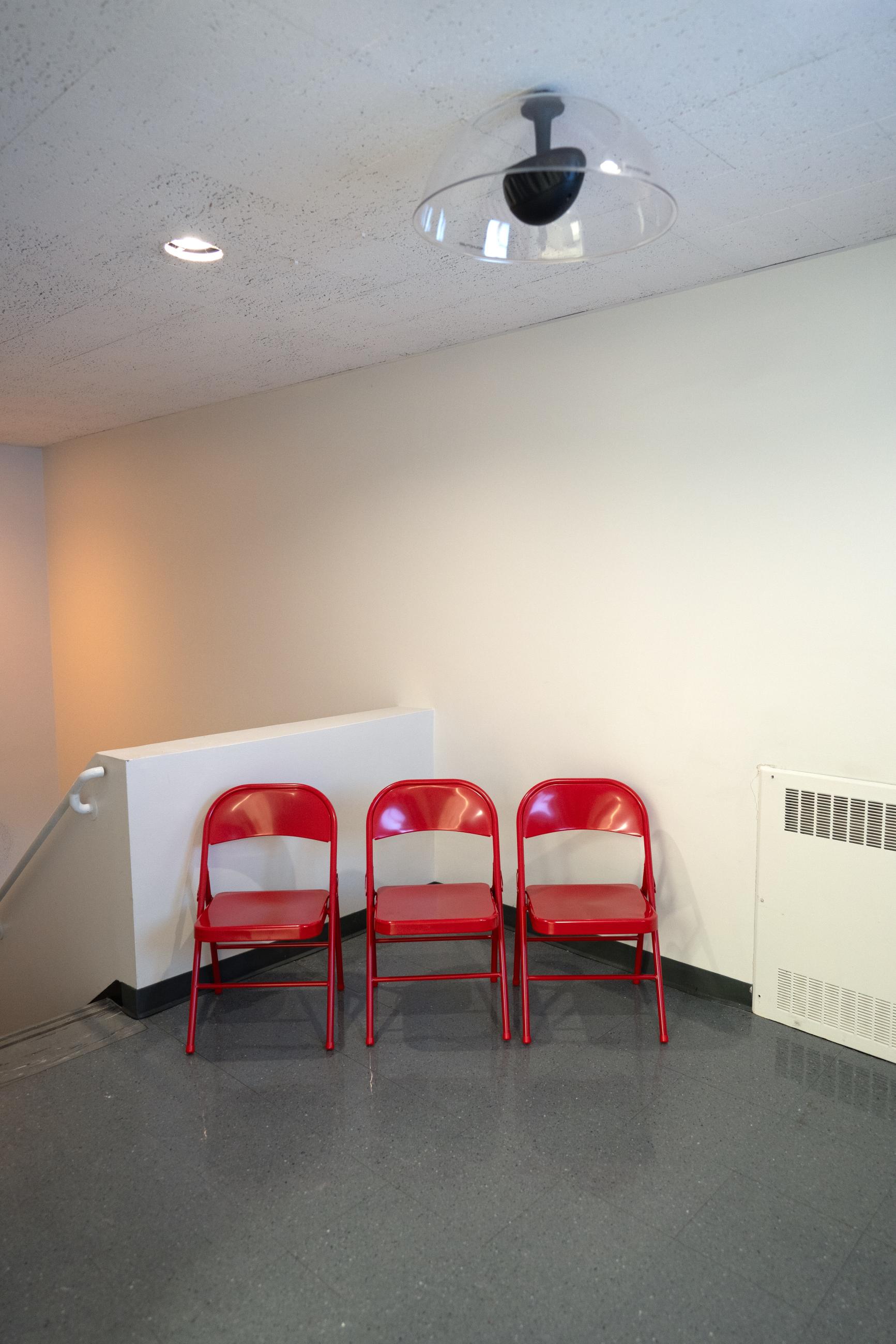 Three red folding chairs