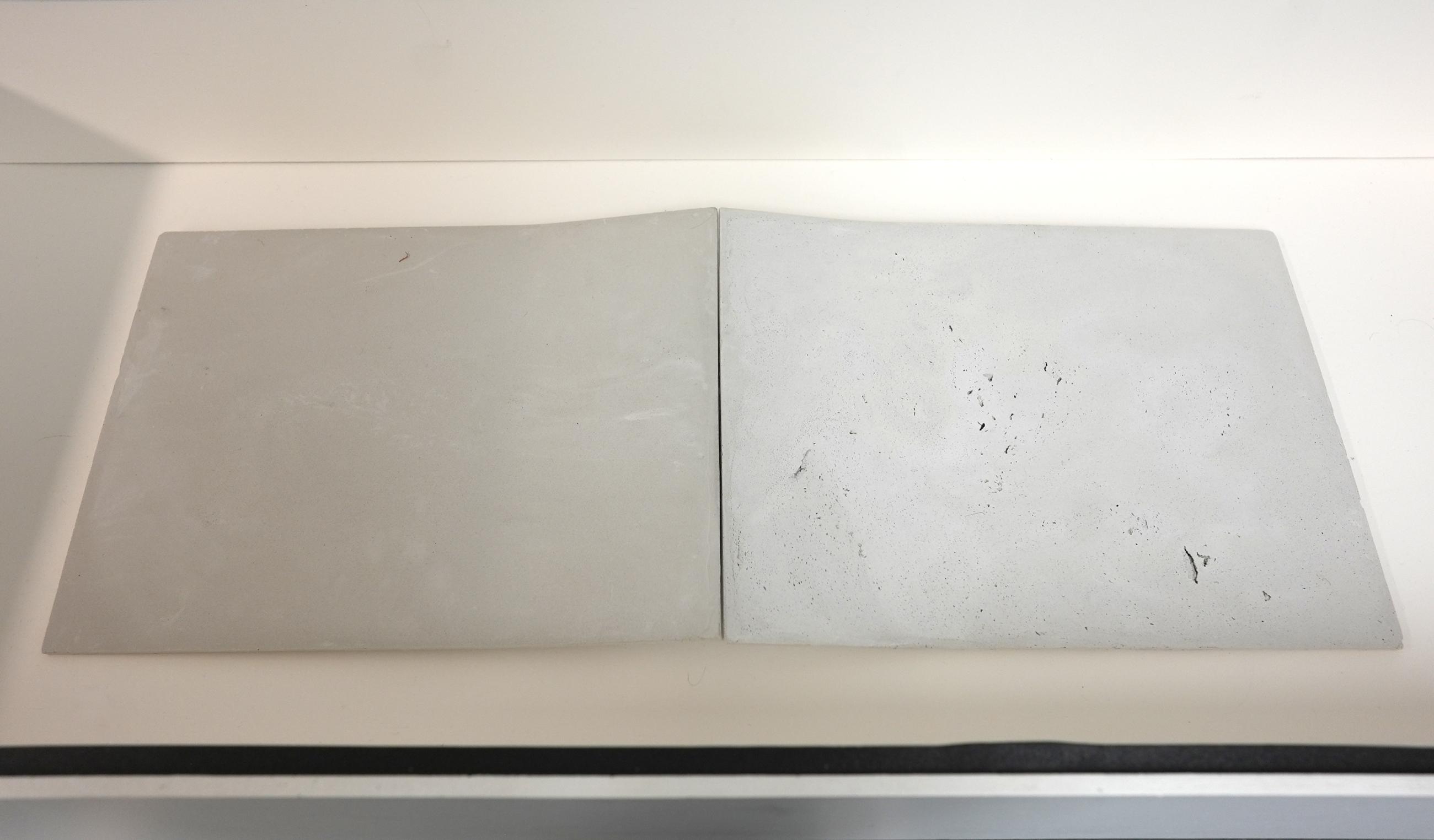 Rectangular sculpture made of concrete laying in a case