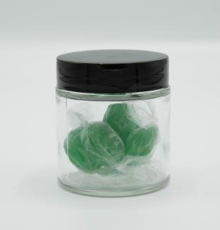 Small jar of cellophane wrapped green candies